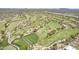 Expansive aerial view of a golf course showcasing lush green fairways and desert landscaping at 36601 N Mule Train Rd # D1, Carefree, AZ 85377