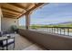 Spacious covered balcony features comfortable seating and stunning views of the surrounding landscape at 36601 N Mule Train Rd # D1, Carefree, AZ 85377