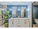 Bathroom featuring double sinks with chrome fixtures, modern lighting and a blue accent wall at 36601 N Mule Train Rd # D1, Carefree, AZ 85377