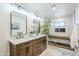 Bright, luxurious bathroom featuring a double vanity, modern lighting, and a glass-enclosed shower at 36601 N Mule Train Rd # D1, Carefree, AZ 85377