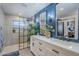 Stylish bathroom features a double vanity, an enclosed shower with a rainfall showerhead, and modern finishes at 36601 N Mule Train Rd # D1, Carefree, AZ 85377