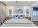 Bright bedroom showcasing stylish decor, neutral tones, and ample natural light creating a serene and inviting atmosphere at 36601 N Mule Train Rd # D1, Carefree, AZ 85377