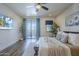 Spacious bedroom with decorative sconces, ceiling fan and access to a private balcony with mountain views at 36601 N Mule Train Rd # D1, Carefree, AZ 85377