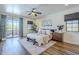 Spacious bedroom with decorative sconces, ceiling fan and a door to a private balcony with mountain views at 36601 N Mule Train Rd # D1, Carefree, AZ 85377