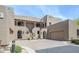 Sand-colored southwestern home with covered balconies, gated entrances, and a two-car garage at 36601 N Mule Train Rd # D1, Carefree, AZ 85377