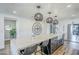 Kitchen with marble countertop, white cabinets, modern lighting, bar seating, and stainless appliances at 36601 N Mule Train Rd # D1, Carefree, AZ 85377