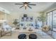 Bright living room featuring a ceiling fan, recessed lighting and white furniture with blue accent pillows at 36601 N Mule Train Rd # D1, Carefree, AZ 85377
