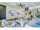 This light and bright living room features recessed lighting, a ceiling fan and white furniture with blue accent pillows at 36601 N Mule Train Rd # D1, Carefree, AZ 85377