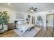 Airy main bedroom with wood-look floors, ceiling fan, an ensuite bathroom, and lots of natural light at 36601 N Mule Train Rd # D1, Carefree, AZ 85377