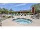 Beautiful pool area featuring a luxurious spa, several lounge chairs, and desert landscaping at 36601 N Mule Train Rd # D1, Carefree, AZ 85377