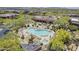 Aerial view of the community pool area featuring desert landscape, lounge chairs, and clear blue water at 36601 N Mule Train Rd # D1, Carefree, AZ 85377