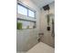 Modern tiled shower with niche, a shower head and handheld sprayer at 36601 N Mule Train Rd # D1, Carefree, AZ 85377