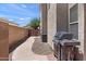 View of backyard with grill, walkway, and block wall fence at 3679 S Cottonwood Ct, Chandler, AZ 85286