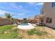 Expansive backyard with a private pool, lush lawn, and a shaded patio area at 3679 S Cottonwood Ct, Chandler, AZ 85286