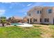 Large backyard with a pool, grass area, and a covered patio for outdoor enjoyment at 3679 S Cottonwood Ct, Chandler, AZ 85286