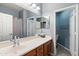 Bathroom featuring a single sink, wood cabinets, a shower with a tub, and a separate toilet room at 3679 S Cottonwood Ct, Chandler, AZ 85286