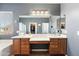 Large main bathroom featuring dual sinks, a large tub, a walk-in shower, and access to the walk-in closet at 3679 S Cottonwood Ct, Chandler, AZ 85286