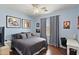 Bedroom featuring wood-look floors, a ceiling fan, and two paintings at 3679 S Cottonwood Ct, Chandler, AZ 85286