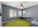 Bedroom featuring wood-look floors, a ceiling fan, and a dedicated workspace at 3679 S Cottonwood Ct, Chandler, AZ 85286