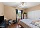 Bedroom featuring wood-look floors, a ceiling fan, and sliding door closet at 3679 S Cottonwood Ct, Chandler, AZ 85286
