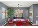Cozy dining area with a bright red table, natural light, and view of the backyard at 3679 S Cottonwood Ct, Chandler, AZ 85286