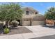 Home boasts a three-car garage, desert landscaping, and neutral paint at 3679 S Cottonwood Ct, Chandler, AZ 85286