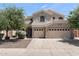 Charming two-story home featuring a three-car garage and a tile roof surrounded by lush greenery at 3679 S Cottonwood Ct, Chandler, AZ 85286