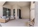 Inviting front porch with comfortable seating, decorative iron door, and neutral color scheme at 3679 S Cottonwood Ct, Chandler, AZ 85286