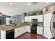 Modern kitchen featuring white cabinets, granite countertops, stainless steel appliances, and recessed lighting at 3679 S Cottonwood Ct, Chandler, AZ 85286