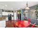 Bright kitchen showcasing white cabinetry, a black appliance suite and a breakfast area with a red table at 3679 S Cottonwood Ct, Chandler, AZ 85286