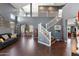 Spacious living room with high ceilings, wood floors, and a staircase leading to an open loft area at 3679 S Cottonwood Ct, Chandler, AZ 85286