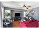Comfortable living room with plush seating, a ceiling fan, and a wall-mounted TV at 3679 S Cottonwood Ct, Chandler, AZ 85286