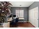Bright home office featuring hardwood floors, a large window, and ample workspace at 3679 S Cottonwood Ct, Chandler, AZ 85286