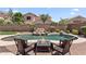 Inviting pool area featuring a rock waterfall and a cozy fire pit with comfortable seating at 3679 S Cottonwood Ct, Chandler, AZ 85286