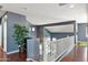 Upstairs landing with hardwood floors, green area rug and a potted tree at 3679 S Cottonwood Ct, Chandler, AZ 85286