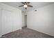 Cozy bedroom with carpet, a ceiling fan, and a double-door closet at 3755 E Broadway Rd # 21, Mesa, AZ 85206