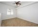 Bedroom with tile floor, large window with blind, neutral colors and ceiling fan at 3755 E Broadway Rd # 21, Mesa, AZ 85206