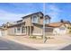 A two-story, brown home with a two-car garage is surrounded by rocks and minimal foliage on a sunny day at 3755 E Broadway Rd # 21, Mesa, AZ 85206