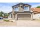 Two-story home featuring a two-car garage and manicured front yard at 3755 E Broadway Rd # 21, Mesa, AZ 85206