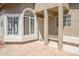 An inviting front entrance features a covered porch with decorative columns and neutral colored brick pavers at 3755 E Broadway Rd # 21, Mesa, AZ 85206