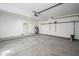A clean, organized garage features a concrete floor, storage racks, and a door to the home's interior at 3755 E Broadway Rd # 21, Mesa, AZ 85206