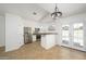 Well-lit kitchen features stainless steel appliances, white cabinets, and access to the pool area at 3755 E Broadway Rd # 21, Mesa, AZ 85206