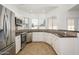 A modern kitchen featuring stainless steel appliances, tiled backsplash, white cabinetry and tiled floor at 3755 E Broadway Rd # 21, Mesa, AZ 85206