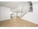Bright living room featuring an open floor plan, tile flooring, and staircase at 3755 E Broadway Rd # 21, Mesa, AZ 85206
