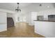A bright, open floor plan showcasing a modern staircase and open view to the kitchen and dining area at 3755 E Broadway Rd # 21, Mesa, AZ 85206