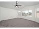 Spacious main bedroom with a ceiling fan and large windows at 3755 E Broadway Rd # 21, Mesa, AZ 85206