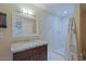 Bathroom features a granite countertop, sink, mirror and shower area at 4132 E Sweetwater Ave, Phoenix, AZ 85032