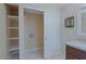 Bright laundry room with open shelving, sink with granite counter, sliding door, and neutral walls at 4132 E Sweetwater Ave, Phoenix, AZ 85032