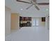 Open living area showcasing tile flooring, a view of kitchen cabinets and access to patio doors at 4132 E Sweetwater Ave, Phoenix, AZ 85032