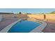 This kidney bean shaped pool has a concrete border and a gravel surround at 4132 E Sweetwater Ave, Phoenix, AZ 85032